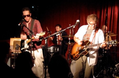 Glenn Mercer and Bill Million attack their guitars.
