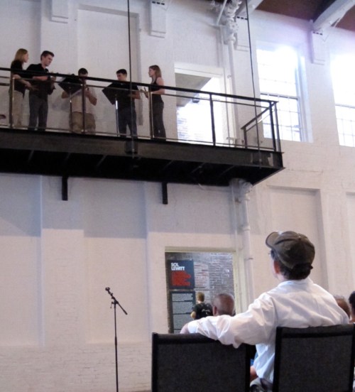 Performing Music for Pieces of Wood while the composer looks on. 