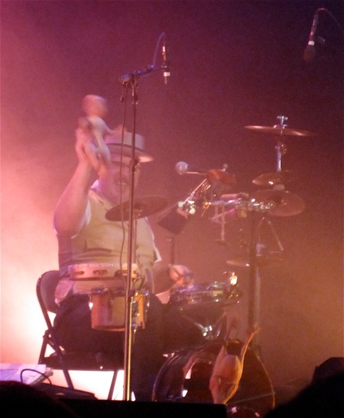 Adrian Huge demonstrates using a baby (a doll, fortunately) as a drum stick.